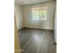 Bright bedroom featuring wood-look floors and window at 5035 N 17Th Ave # 206, Phoenix, AZ 85015