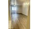 A bright living room with laminate floors and a sliding glass door to a balcony at 5035 N 17Th Ave # 206, Phoenix, AZ 85015