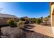 Landscaped backyard with desert plants and brick pavers at 5219 W Buckskin Dr, Eloy, AZ 85131