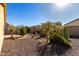 Backyard with desert landscaping and a paved walkway at 5219 W Buckskin Dr, Eloy, AZ 85131