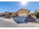 Single story home with a two-car garage and desert landscaping at 5219 W Buckskin Dr, Eloy, AZ 85131