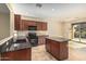 Modern kitchen featuring granite countertops and dark wood cabinetry at 5219 W Buckskin Dr, Eloy, AZ 85131