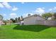 Large grassy backyard with a view of the home's side elevation at 527 N Valencia Pl, Chandler, AZ 85226