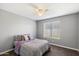 Cozy bedroom with neutral walls, carpet flooring and a ceiling fan at 527 N Valencia Pl, Chandler, AZ 85226