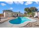 Inviting kidney shaped pool surrounded by a rock landscape in the backyard at 527 N Valencia Pl, Chandler, AZ 85226