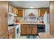 Kitchen with wood cabinets, sink, and appliances at 535 S Alma School Rd # 113, Mesa, AZ 85210