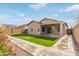 Artificial turf backyard with putting green and patio at 5590 W Victory Way, Florence, AZ 85132