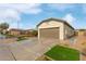 Side view of a house with a two-car garage and artificial turf at 5590 W Victory Way, Florence, AZ 85132