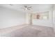 Bright living room with tile and carpeted floors, and a view into the kitchen at 5590 W Victory Way, Florence, AZ 85132