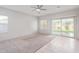 Living room with carpeted floor, tile flooring, and sliding glass door at 5590 W Victory Way, Florence, AZ 85132