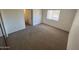 This bedroom features a window for natural light and neutral carpeting at 6550 N 47Th Ave # 286, Glendale, AZ 85301