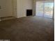 Spacious living room featuring plush carpeting and a sliding glass door for natural light at 6550 N 47Th Ave # 286, Glendale, AZ 85301