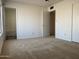 Bright bedroom with carpet flooring, and access to bathroom at 702 W Grove Cir, Mesa, AZ 85210