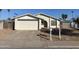 Ranch style home with a two-car garage and a desert landscape at 702 W Grove Cir, Mesa, AZ 85210