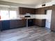 Galley style kitchen with wood cabinets and laminate flooring at 702 W Grove Cir, Mesa, AZ 85210