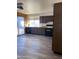 Kitchen with wood cabinets, black appliances, and laminate floor at 702 W Grove Cir, Mesa, AZ 85210