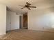 Spacious living area with ceiling fan and wall-to-wall carpet at 702 W Grove Cir, Mesa, AZ 85210