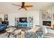 Living room with fireplace, hardwood floors, and ceiling fan at 7313 E Pleasant E Run, Scottsdale, AZ 85258