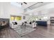 Modern kitchen with white cabinets, a blue island, and stainless steel appliances at 9144 E Pershing Ave, Scottsdale, AZ 85260