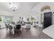 Open concept living and dining area with hardwood floors and modern furniture at 9144 E Pershing Ave, Scottsdale, AZ 85260