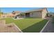 Artificial turf backyard with pool and patio furniture at 9184 W Donald Dr, Peoria, AZ 85383