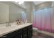 Clean bathroom with dark vanity and bathtub at 9184 W Donald Dr, Peoria, AZ 85383