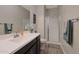 Bathroom with vanity, shower, and linen storage at 9184 W Donald Dr, Peoria, AZ 85383