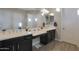 Bathroom features double vanity with dark wood cabinets and white countertop at 9184 W Donald Dr, Peoria, AZ 85383