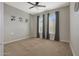 Bright bedroom with ceiling fan, neutral carpeting, and large windows at 9184 W Donald Dr, Peoria, AZ 85383