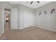 Well-lit bedroom with door to hallway and double door closet at 9184 W Donald Dr, Peoria, AZ 85383