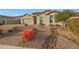 House exterior with a paved pathway, drought-resistant landscaping, and a two-car garage at 9184 W Donald Dr, Peoria, AZ 85383