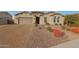 Single-story home with a two-car garage and well-manicured landscaping at 9184 W Donald Dr, Peoria, AZ 85383