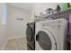 Laundry room with washer, dryer, and shelving at 9184 W Donald Dr, Peoria, AZ 85383