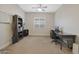 Home office with a large desk, built-in shelving, and plenty of natural light at 9184 W Donald Dr, Peoria, AZ 85383