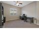 Home office with a large desk, built-in shelving, and plenty of natural light at 9184 W Donald Dr, Peoria, AZ 85383