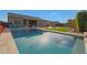 Inviting backyard oasis featuring a refreshing pool and lush green lawn at 9184 W Donald Dr, Peoria, AZ 85383