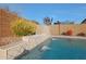 Modern pool with waterfall feature and stone coping at 9184 W Donald Dr, Peoria, AZ 85383