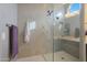 Spacious shower with glass enclosure and neutral tile at 9184 W Donald Dr, Peoria, AZ 85383