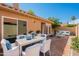 Outdoor patio space featuring a dining set, cushioned seating, and a well-manicured landscape at 9288 E Camino Del Santo --, Scottsdale, AZ 85260