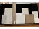 Image showcases a variety of tile, wood, and countertop samples for the home at 1032 W J Waltz Way, Apache Junction, AZ 85120