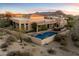 Stunning aerial view of a home with a pool and mountain backdrop at 10874 E Dale Ln, Scottsdale, AZ 85262