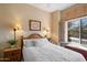 Bright bedroom with wood furniture and window seat at 10874 E Dale Ln, Scottsdale, AZ 85262