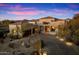 Beautiful desert home with a long driveway and landscaping at 10874 E Dale Ln, Scottsdale, AZ 85262