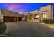 Desert home with a two-car garage and landscaped yard at 10874 E Dale Ln, Scottsdale, AZ 85262