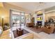 Bright living room featuring a fireplace and large windows at 10874 E Dale Ln, Scottsdale, AZ 85262