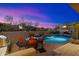 Sunset view of the pool, patio, and landscape at 10874 E Dale Ln, Scottsdale, AZ 85262