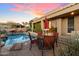 Relaxing pool area with patio furniture and sunset view at 10874 E Dale Ln, Scottsdale, AZ 85262