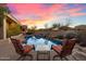 Inviting pool area with seating and stunning sunset views at 10874 E Dale Ln, Scottsdale, AZ 85262