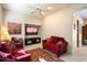 Cozy sitting area with red couches and a built-in TV at 10874 E Dale Ln, Scottsdale, AZ 85262