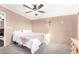 Relaxing bedroom with a king-size bed and ceiling fan at 10951 N 91St Ave # 56, Peoria, AZ 85345